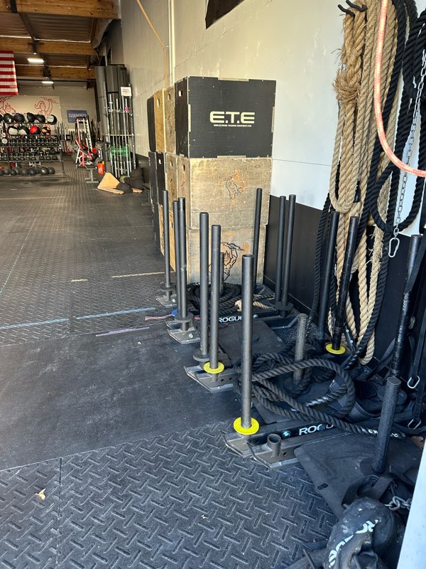 Push sleds, battle ropes and plyo boxes in the turf area.