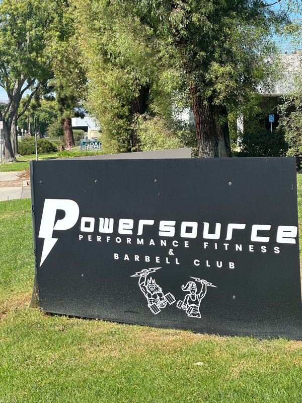 The PowerSource Performance Fitness banner at an outdoor testing day.