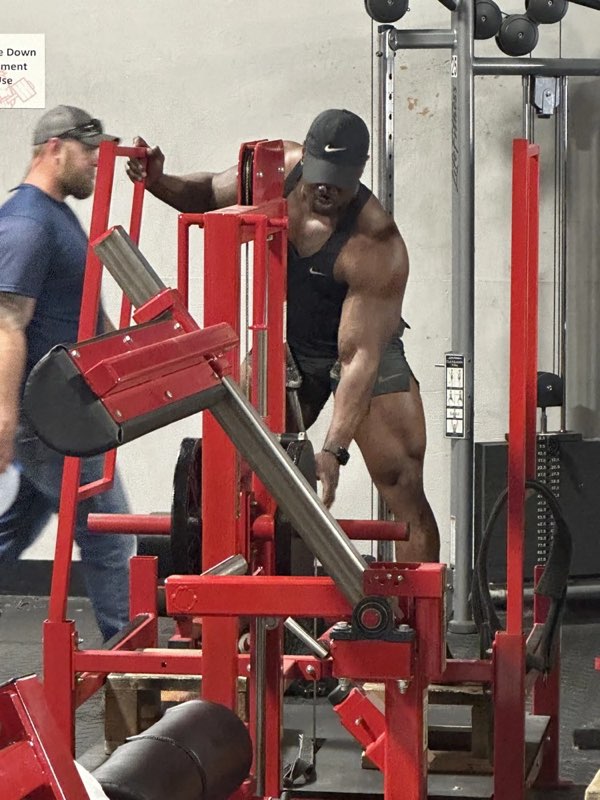 A member training on a plate-loaded machine.
